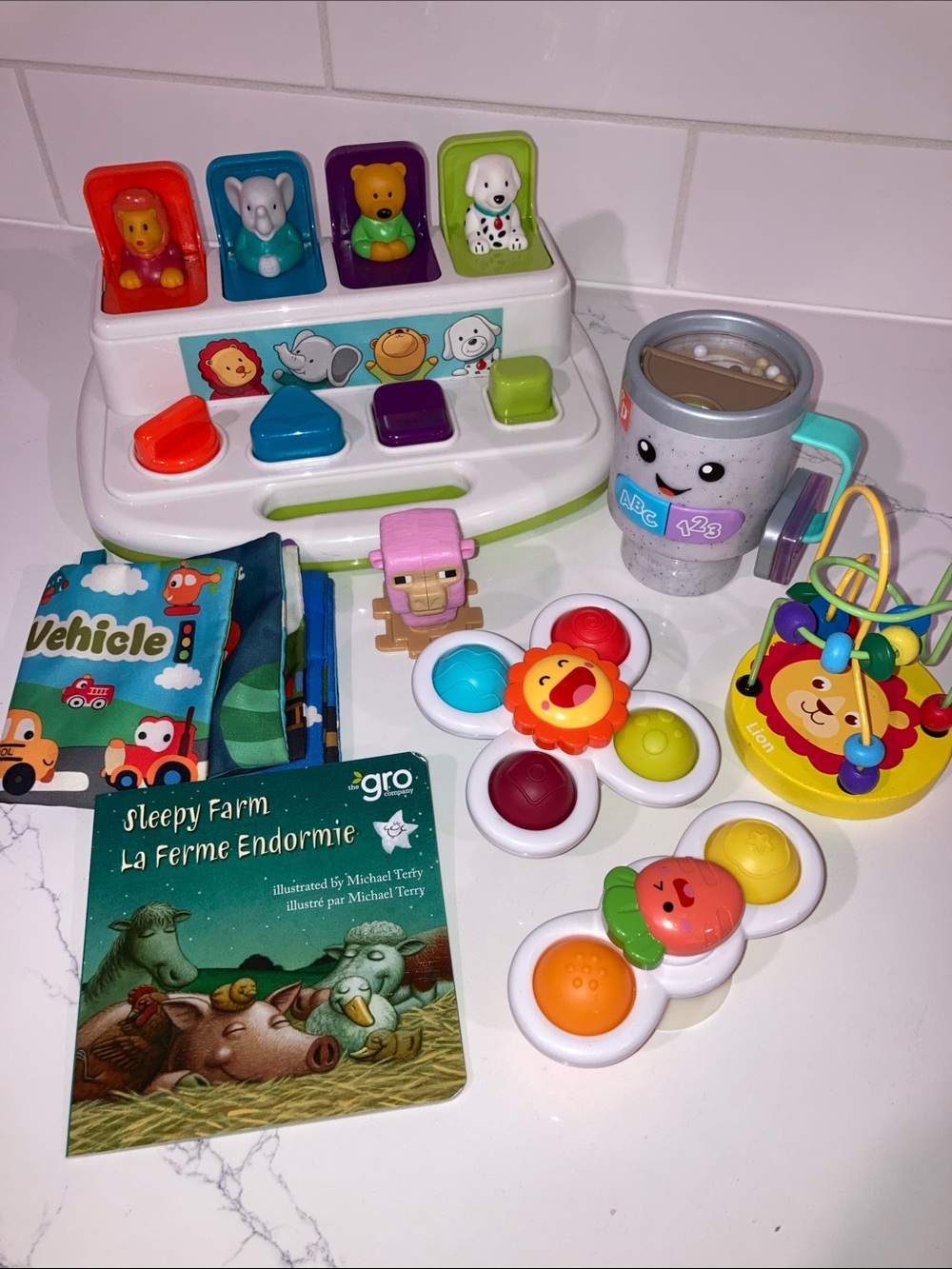 (5/$5) Lot of Baby Toys (8PC) - Books, Spinning Pop Its, Coffee Mug